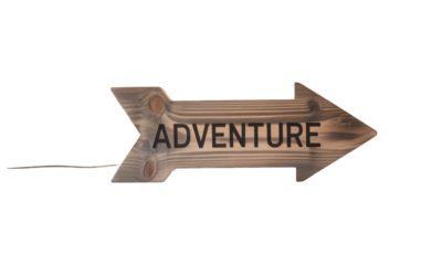 Wooden arrow sign reading "ADVENTURE", mounted on dark background