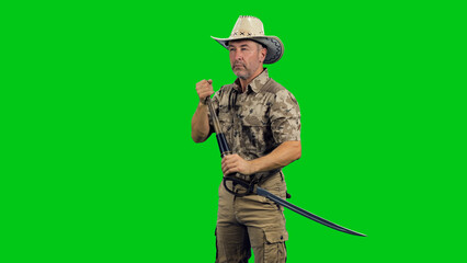 Cinematic style of middle aged stern man ranger wearing camouflage with cowboy hat standing with...