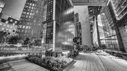 Wide view of the elevated urban park with skyscrapers and nighttime ambiance in Manhattan
