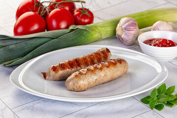 Grilled pork sausages served tomato sauce