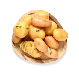 Wooden plate with raw baby potatoes and thyme on white background