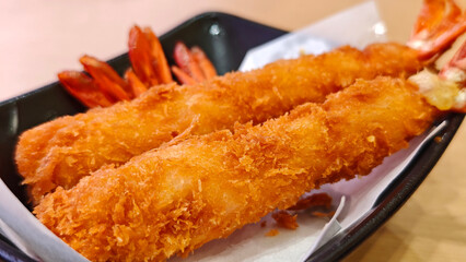 Fried shrimp on a black plate