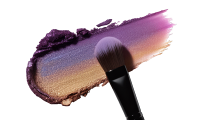 Makeup brush blending purple, blue, and gold eyeshadow smear