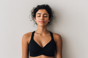 Fototapeta premium young woman in stylish sports top takes deep breath embodying relaxation and focus