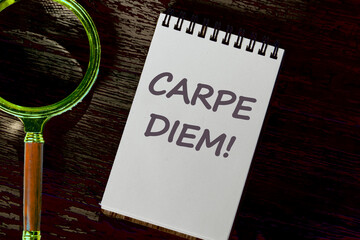 Carpe Diem Phrase It means Seize the moment in a white notebook on a dark mysterious background