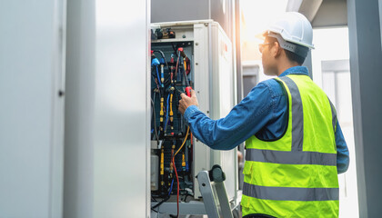 Professional technician checking a machine for air conditioning performance and maintenance in a clean indoor environment