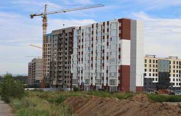 Modern apartment buildings under construction. New residential area. Urbanization. Ust-Kamenogorsk...