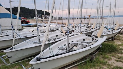 sailboats on the beach at sunset