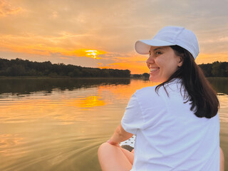 Woman Taking Selfie on Paddleboard at Sunset