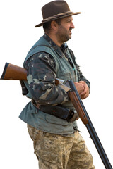 Mature hunter man holding a shotgun and walking through a field