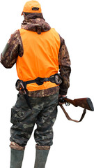 Mature hunter man holding a shotgun and walking through a field