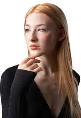 Portrait of a blonde woman with freckles in a sexy top and denim shorts in a studio.