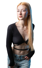 Portrait of a blonde woman with freckles in a sexy top and denim shorts in a studio.