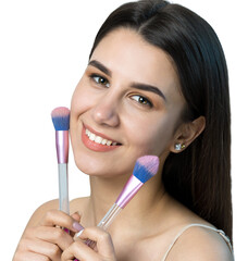 Close-up of a young girl in a light top on a white background making a facial make-up. A pretty woman holds a cosmetic brush near her face and smiles.