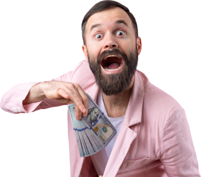 Portrait of a contented young businessman with a beard dressed in a pink jacket showing us dollar banknotes against a red studio background. Taste, smell of money.