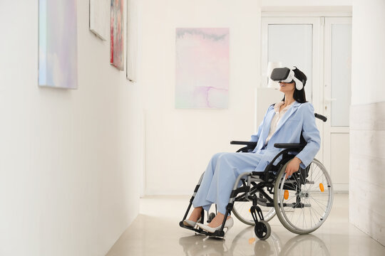Young woman in wheelchair with VR glasses visiting art gallery - Powered by Adobe
