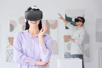 Young woman with VR glasses in modern art gallery