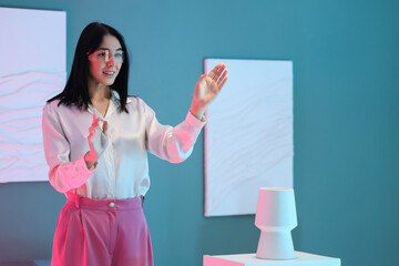 Young woman with VR glasses near exhibit in modern art gallery