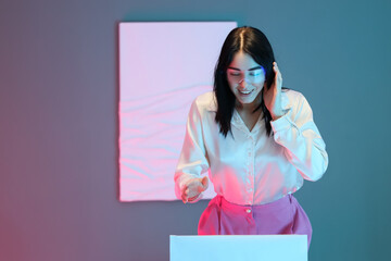 Young woman with VR glasses near exhibit in modern art gallery