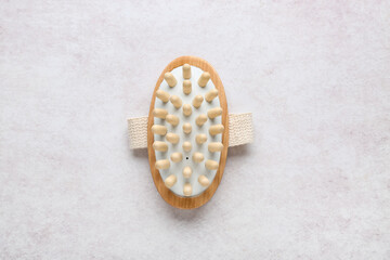 Massage body brush on white background, closeup