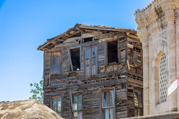 Old Abandoned Wooden House Beside Historical Stone Building
