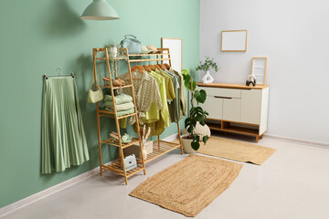 Interior of clothing store with rack, accessories and plants