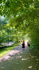 Serene walking trail following the tranquil Frogner River in Oslo, Norway, surrounded by lush greenery and natural beauty.