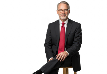 Confident businessman in suit and red tie wearing glasses sitting on stool isolated on transparent background