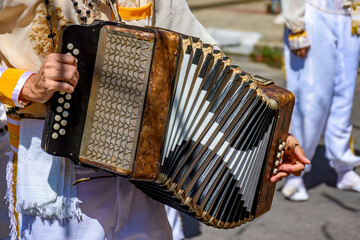 Accordionist playing his instrument at the Congado festival in the streets of Minas Gerais