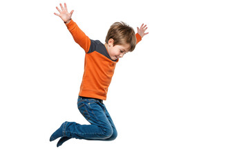 A young boy in an orange shirt and blue jeans jumping with arms raised, isolated on transparent background