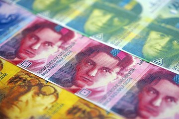 Swiss franc banknotes. The current francs money bills lies on table in big amount close up