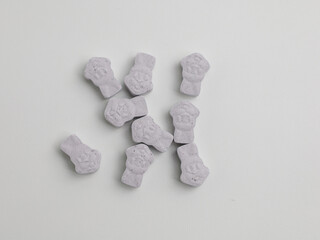 Pills or candy vitamin on white background