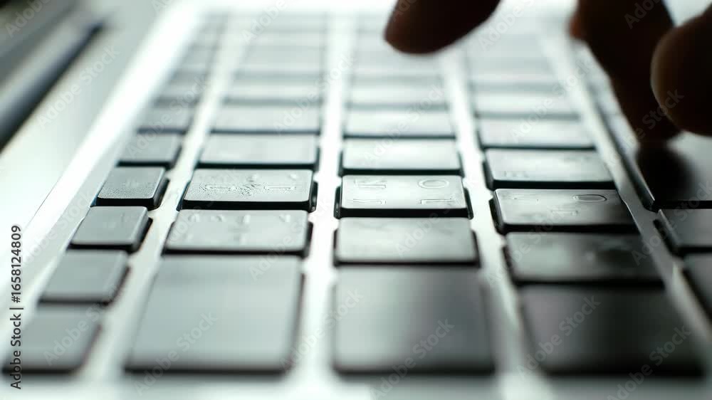 Poster typing on keyboard, close up of hands and keys