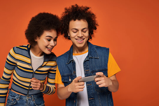 Exciting moments shared between two friends enjoying a smartphone together