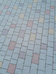 Texture of street tiles. Pattern of gray sidewalk tiles close up
