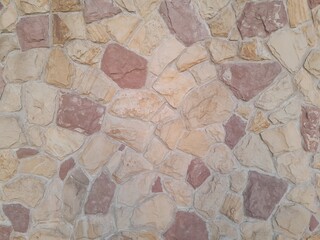 Background of stone wall texture photo in brown and red colors