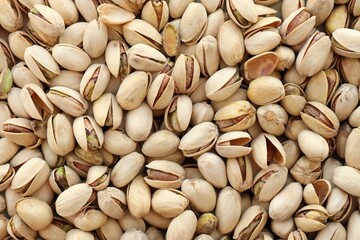Tasty unpeeled pistachios as background, top view flat lay background