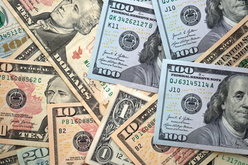 Big amount of different dollar bills close up. Hundred fifty twenty ten and five dollar banknotes
