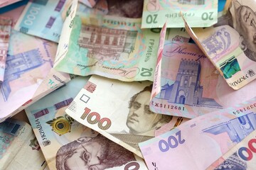 Big amount of different Ukrainian hryvnia money bills. Pile of crumpled ukrainian banknotes
