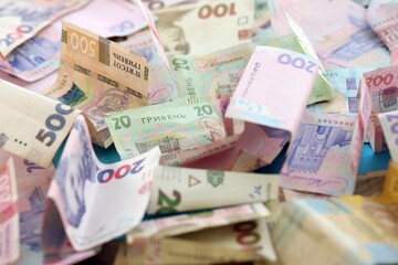 Big amount of different Ukrainian hryvnia money bills. Pile of crumpled ukrainian banknotes