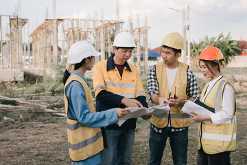 Male and female engineers who are Asian professionals in the construction industry focus on village...