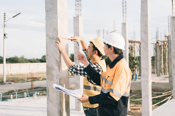 Male and female engineers who are Asian professionals in the construction industry focus on village...