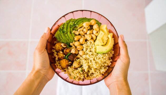 Close-up of hands holding a bowl of vibrant, healthy, and delicious food