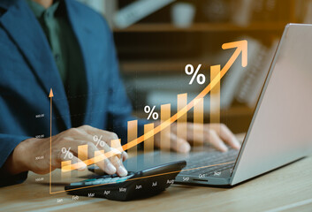 Interest rate concept, Business man using calculator with graph percentage symbol and up arrow,...