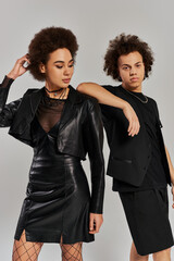 Young models showcase edgy black fashion styles in a trendy studio setting