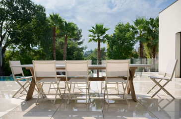 TABLE AND CHAIRS ON TERRACE AFTER THE RAIN