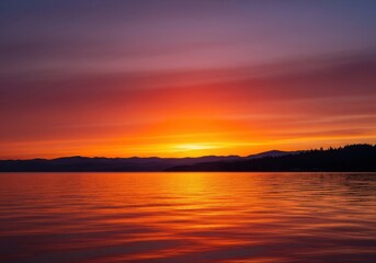 Fototapeta premium Sunset over a lake and river with colorful sky and calm water reflecting the sunlight