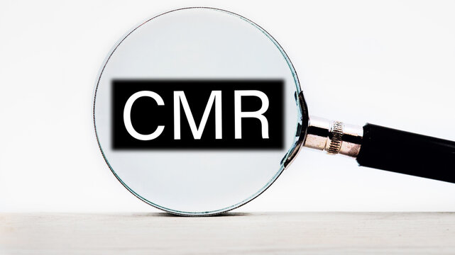 CMR Contract Management Review or Clear Motion Rate lettering on through a magnifying glass on a light background
