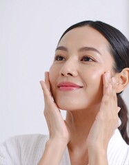 Woman applying facial treatment