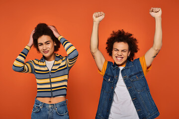 Dynamic expression of joy and style with curly hair against a vibrant backdrop